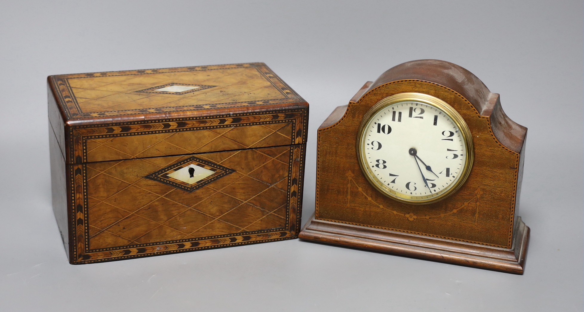 A Victorian walnut and marquetry tea caddy and an inlaid mahogany mantel timepiece, box 20 cms wide 13 cms high